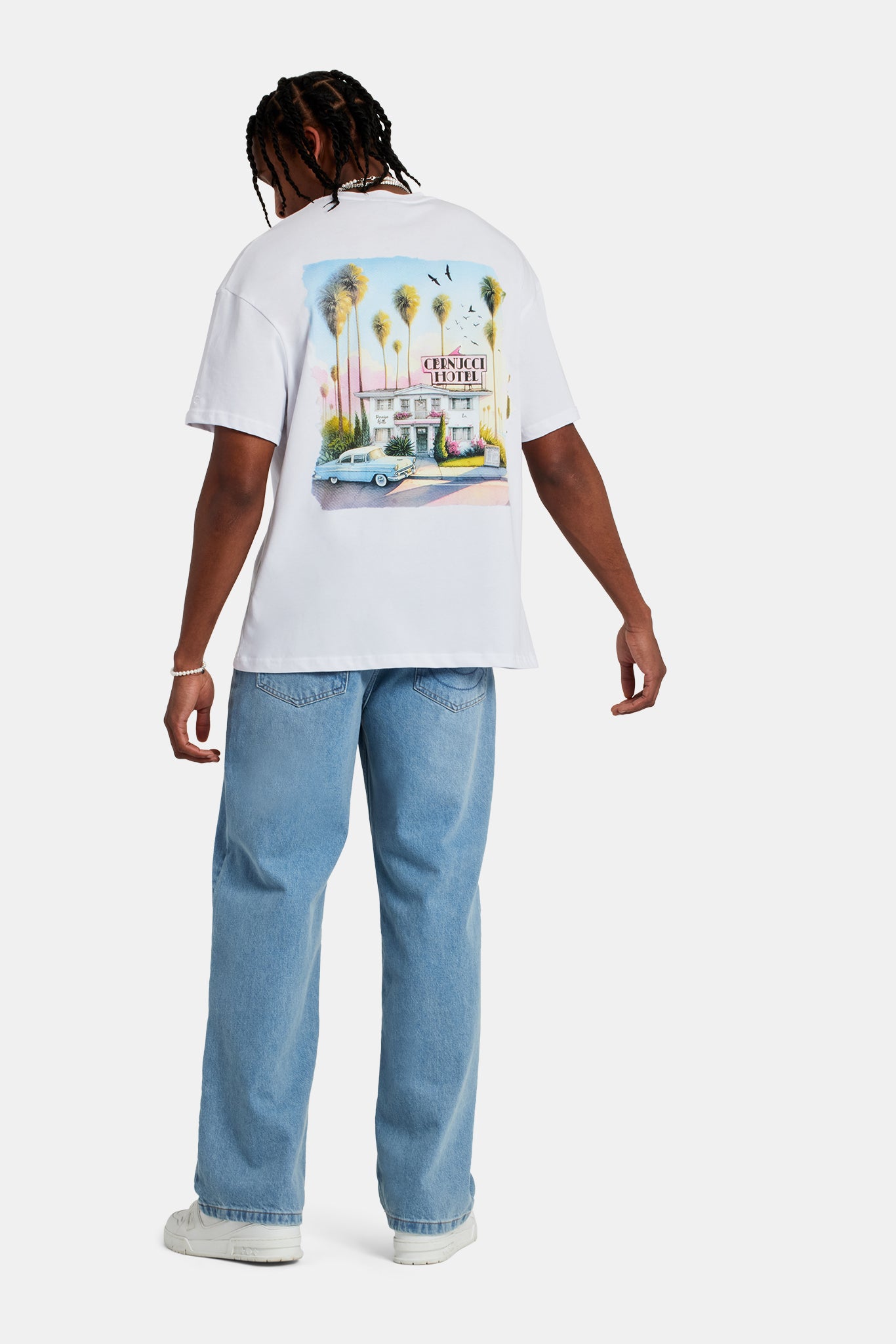 Male model wearing the oversized hotel print t-shirt in white